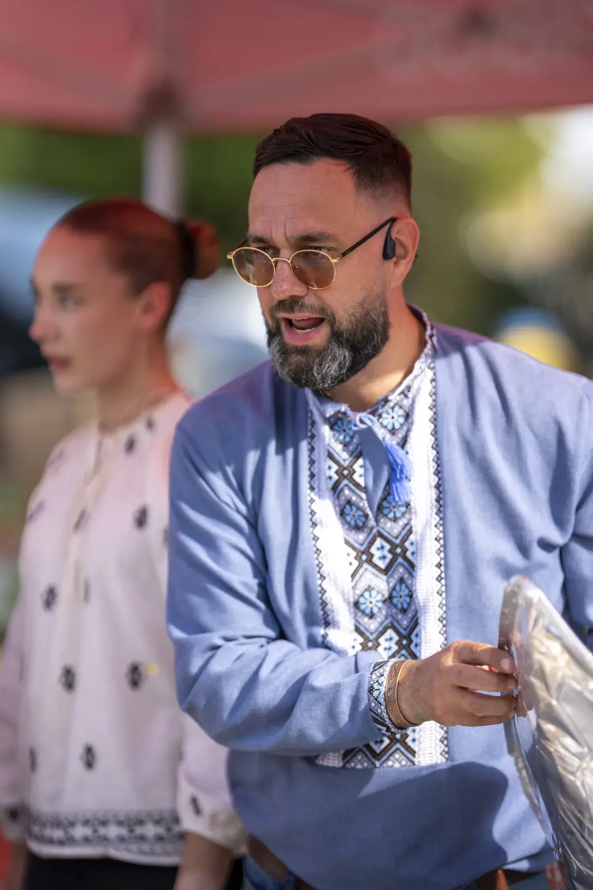 Maksym Stepanenko at UAFest 2026 — Man in an embroidered shirt serves food at a tent (photo: Tim Skinner)