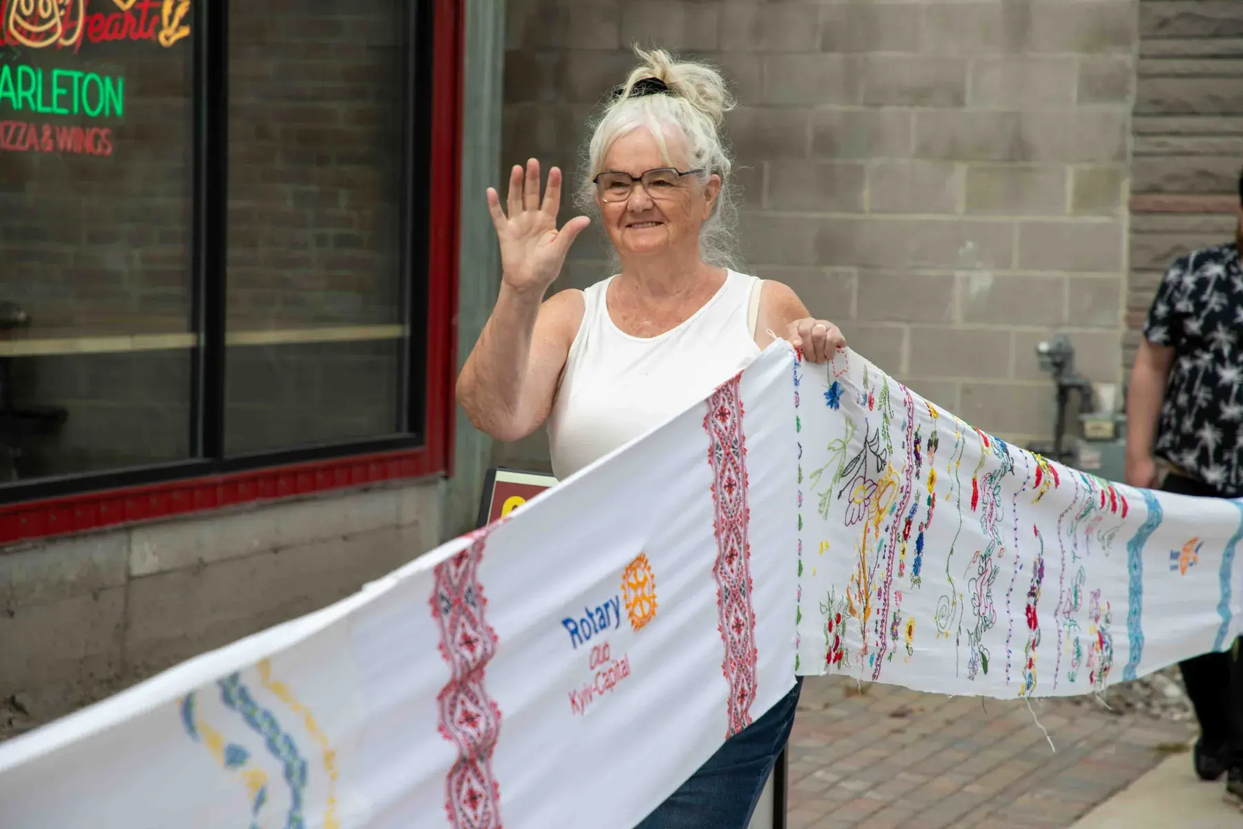 A participant waves while carrying the rushnyk