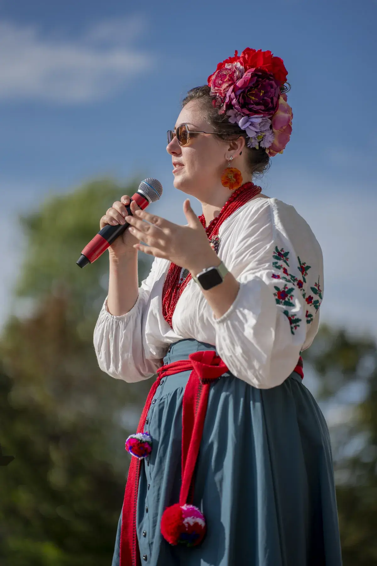 Olga Ostafiichuk at UAFest 2026 — Host in a floral headdress and embroidered blouse speaking into a microphone (photo: Tim Skinner)