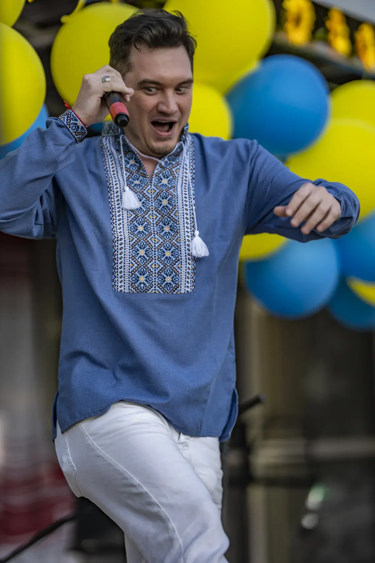 DEN BAURIN at UAFest 2026 — Male singer in a blue vyshyvanka dances across the stage with a microphone (photo: Tim Skinner)