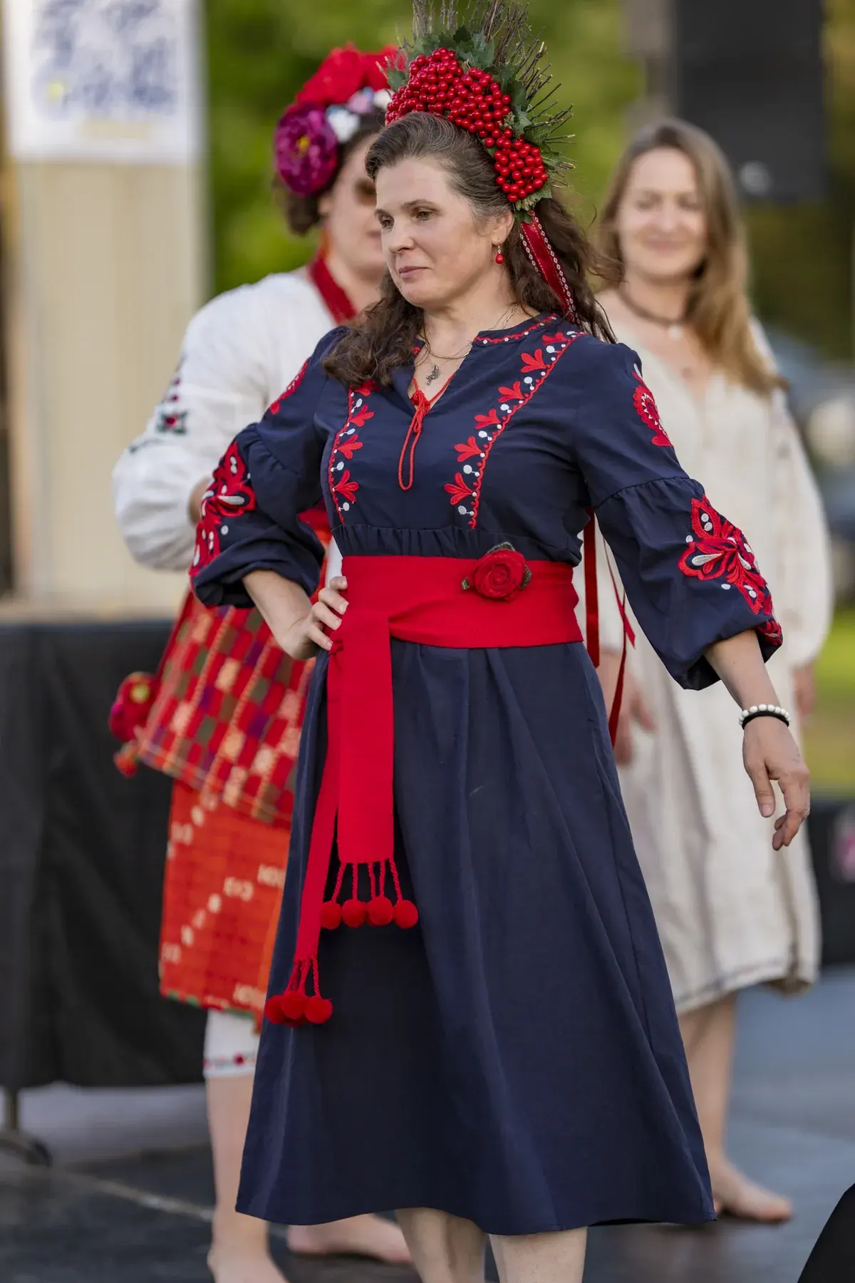 Oksana Pikush at UAFest 2026 — Woman in a viburnum crown shows her navy dress and red sash on stage (photo: Tim Skinner)