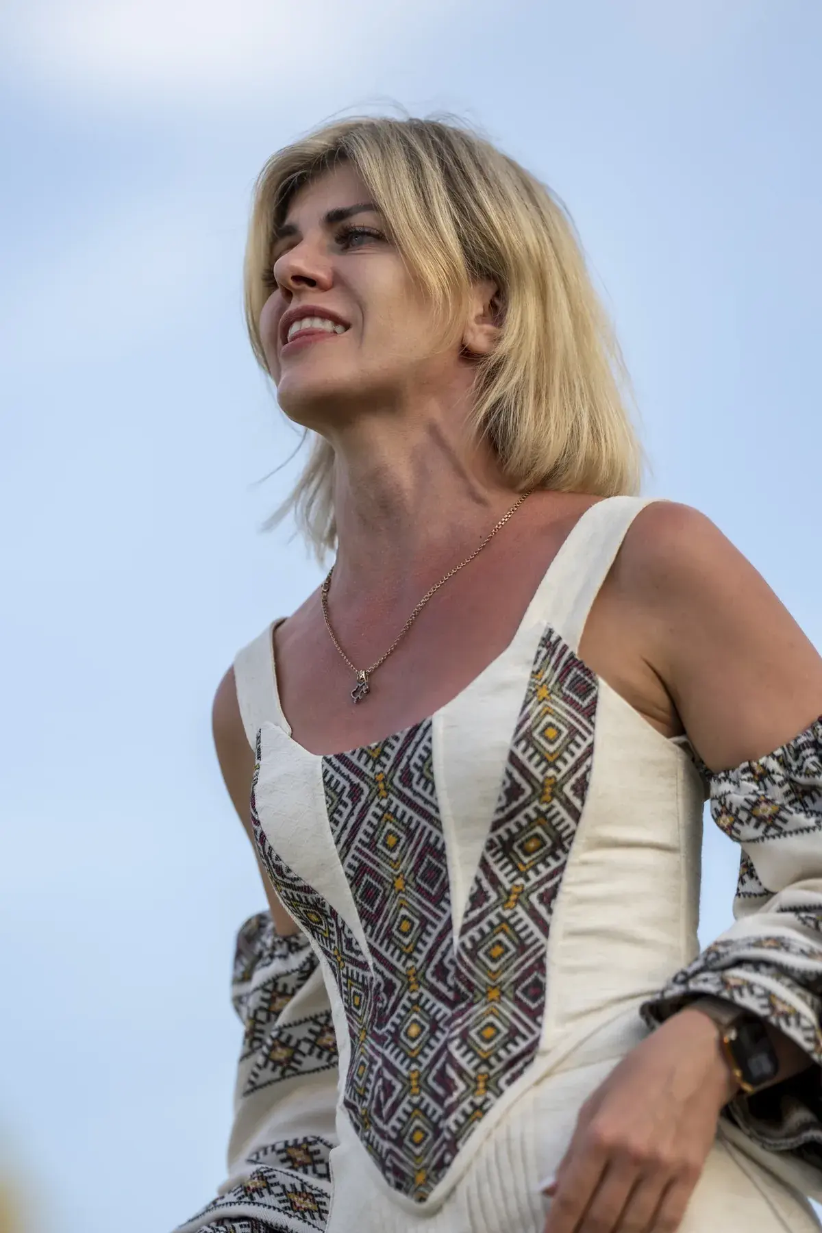 Svitlana Marchuk at UAFest 2026 — Blonde performer in embroidered dress sings with emotion against the sky (photo: Tim Skinner)