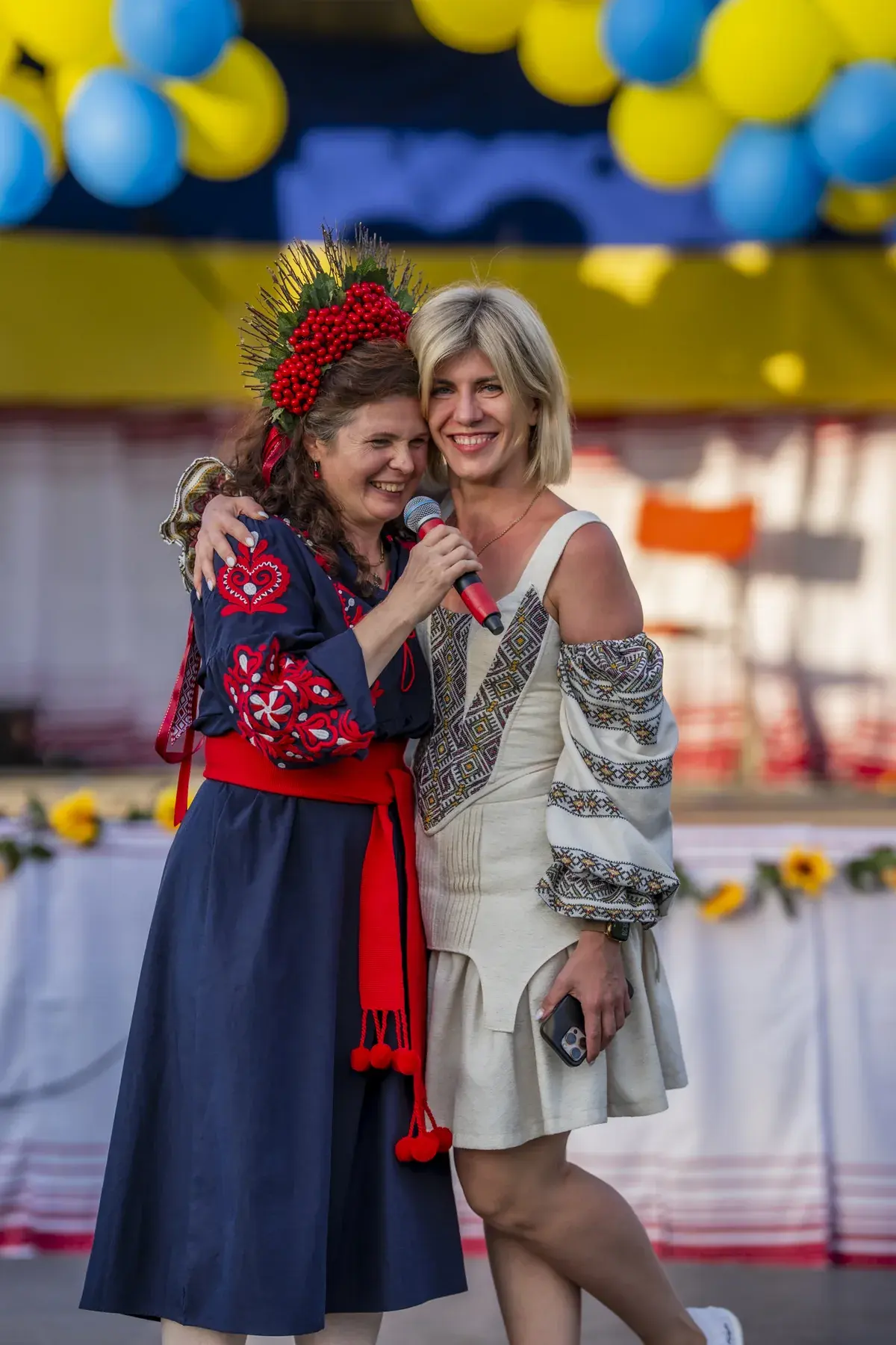 Svitlana Marchuk at UAFest 2026 — Two women in embroidered dresses embrace on stage (photo: Tim Skinner)