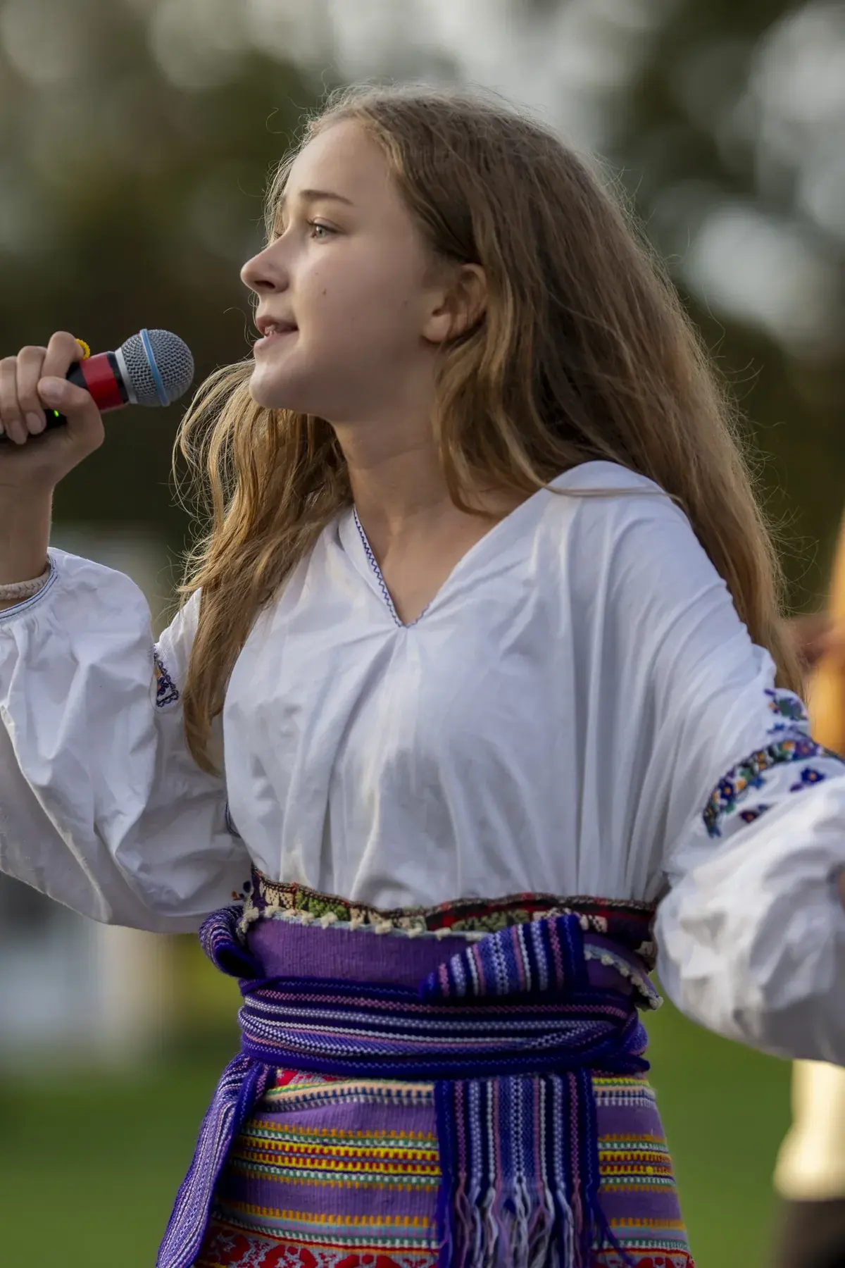Marta Stepanenko at UAFest 2026 — Young singer in profile, warm evening light (photo: Tim Skinner)