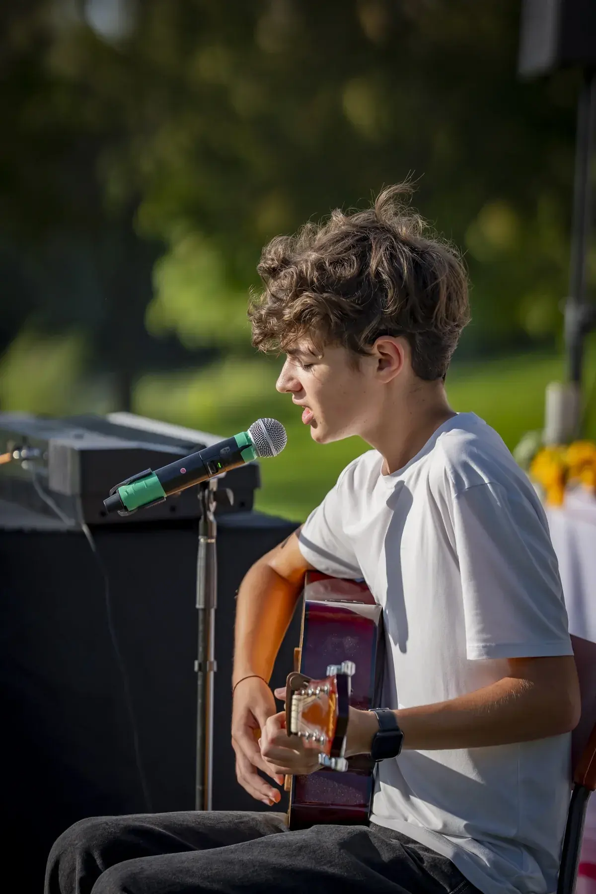Ivan Horobets at UAFest 2026 — Teenage guitarist in a white T-shirt singing at a microphone on stage (photo: Tim Skinner)