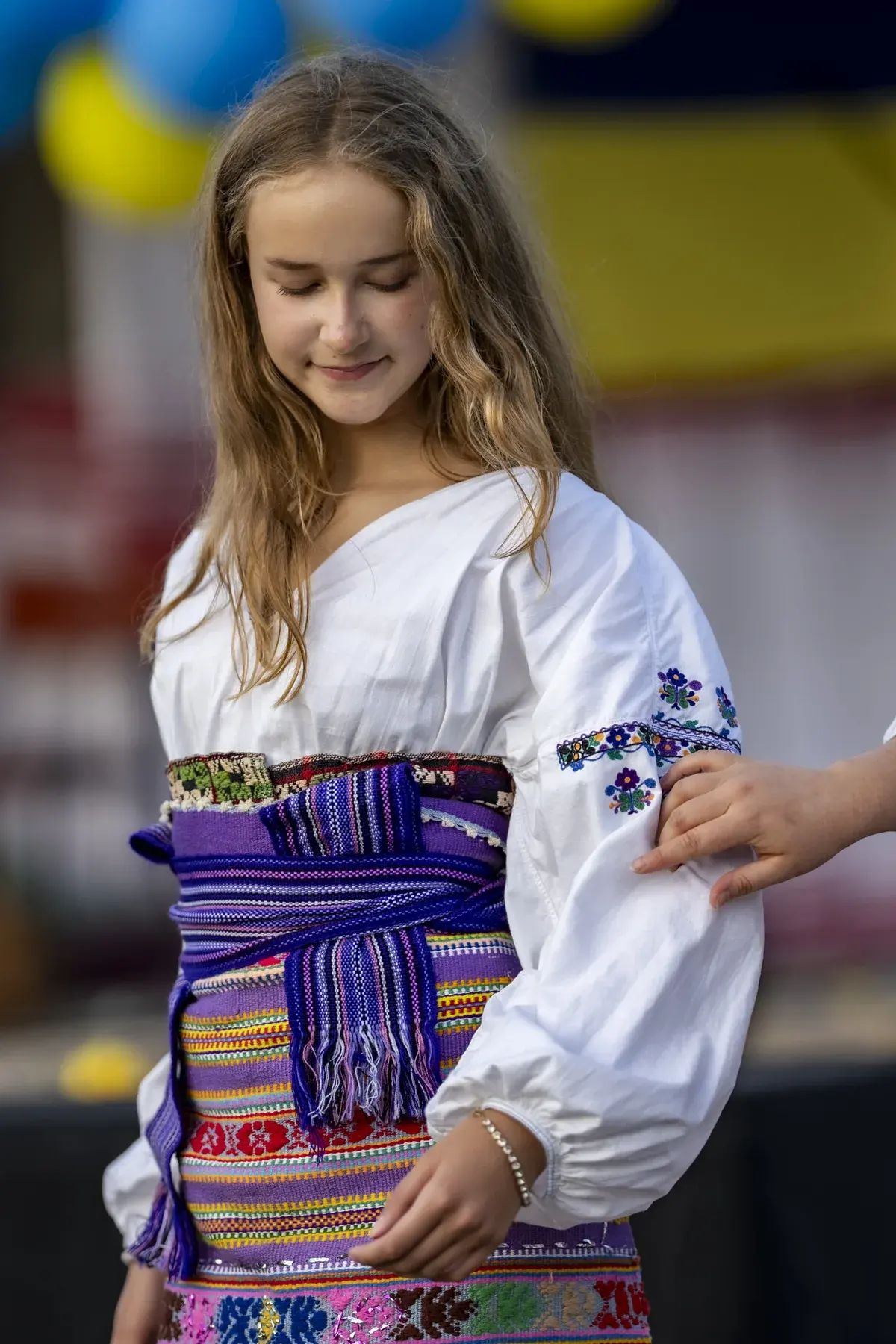 Marta Stepanenko at UAFest 2026 — Teenage girl in a traditional costume with a woven sash dances on stage (photo: Tim Skinner)