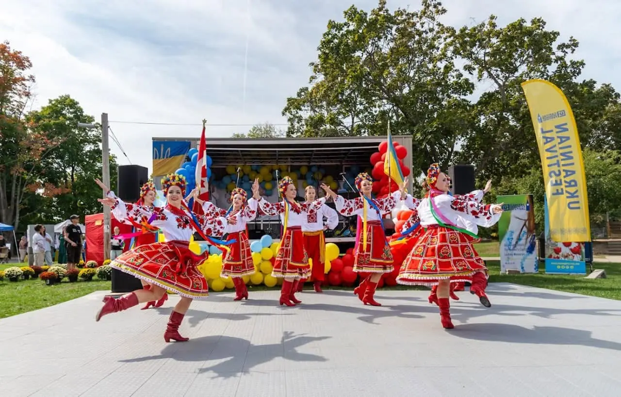 Folk dancers in embroidered costumes performing on the UAFest main stage