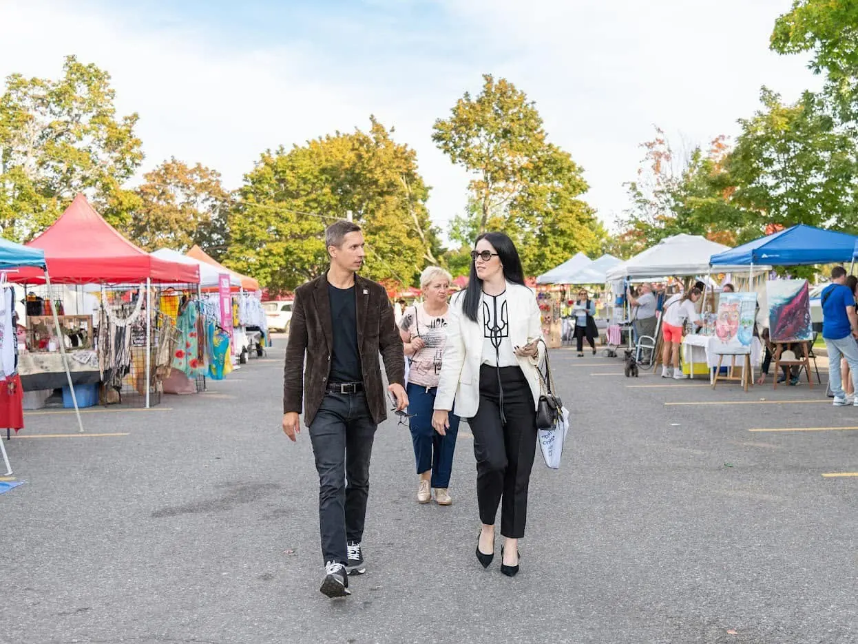 Visitors walking through the vendor market at UAFest