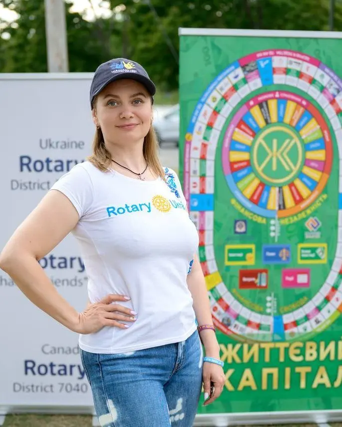 A UAFest volunteer in a Rotary community-partner t-shirt outdoors, from the festival's first year