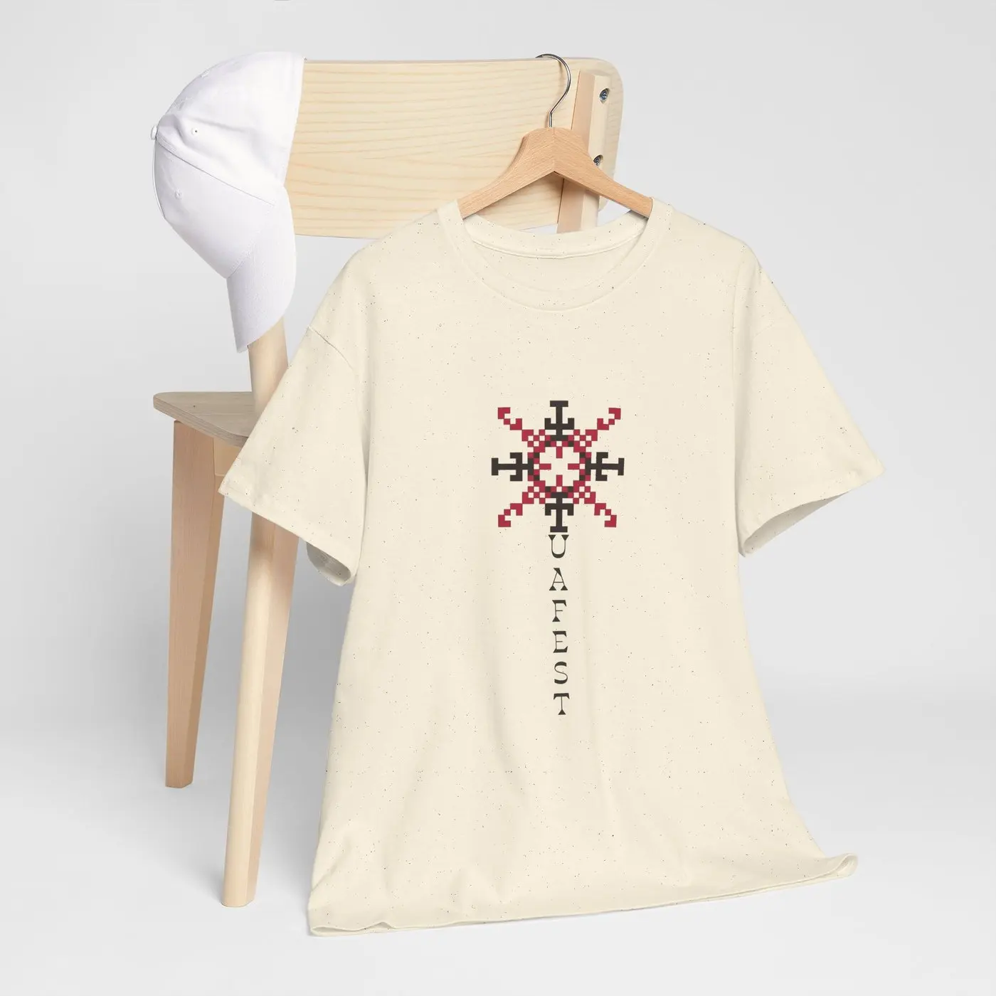 The T-shirt on a wooden hanger beside a light wooden stool