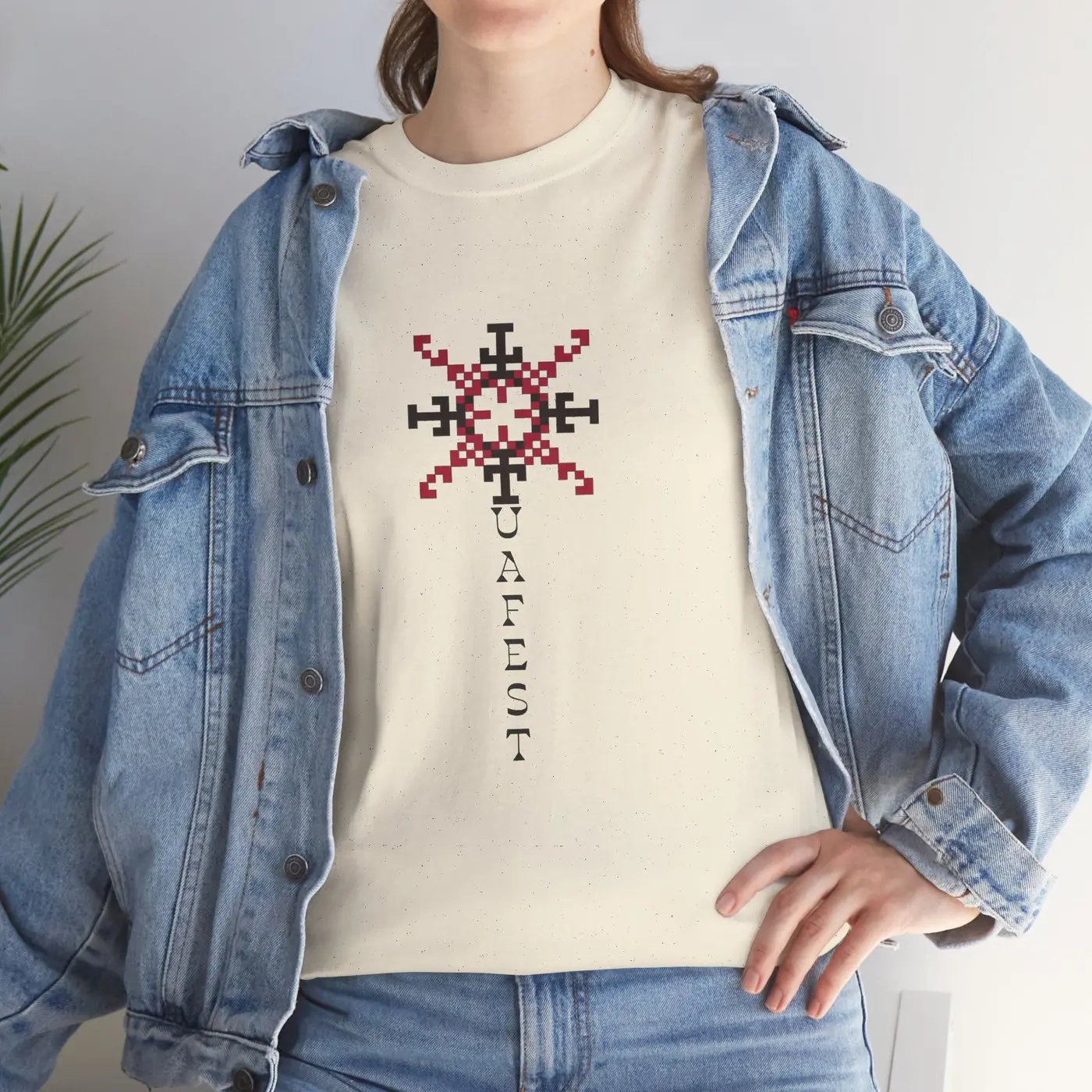The T-shirt worn under an open denim jacket, close up