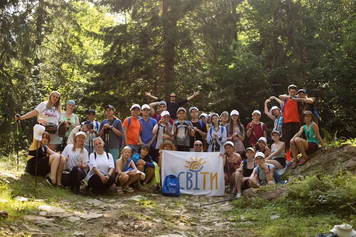 A large group of UAFest volunteers and team members on a forest hike outing together.