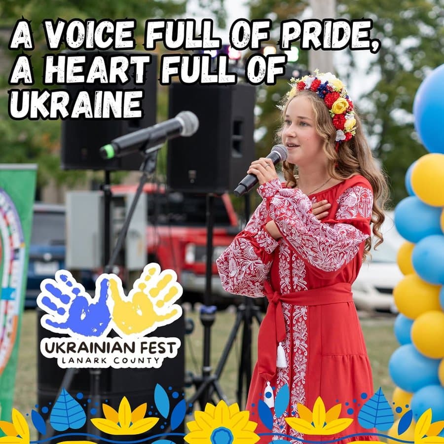 Marta singing on the UAFest stage in a red vyshyvanka and floral wreath