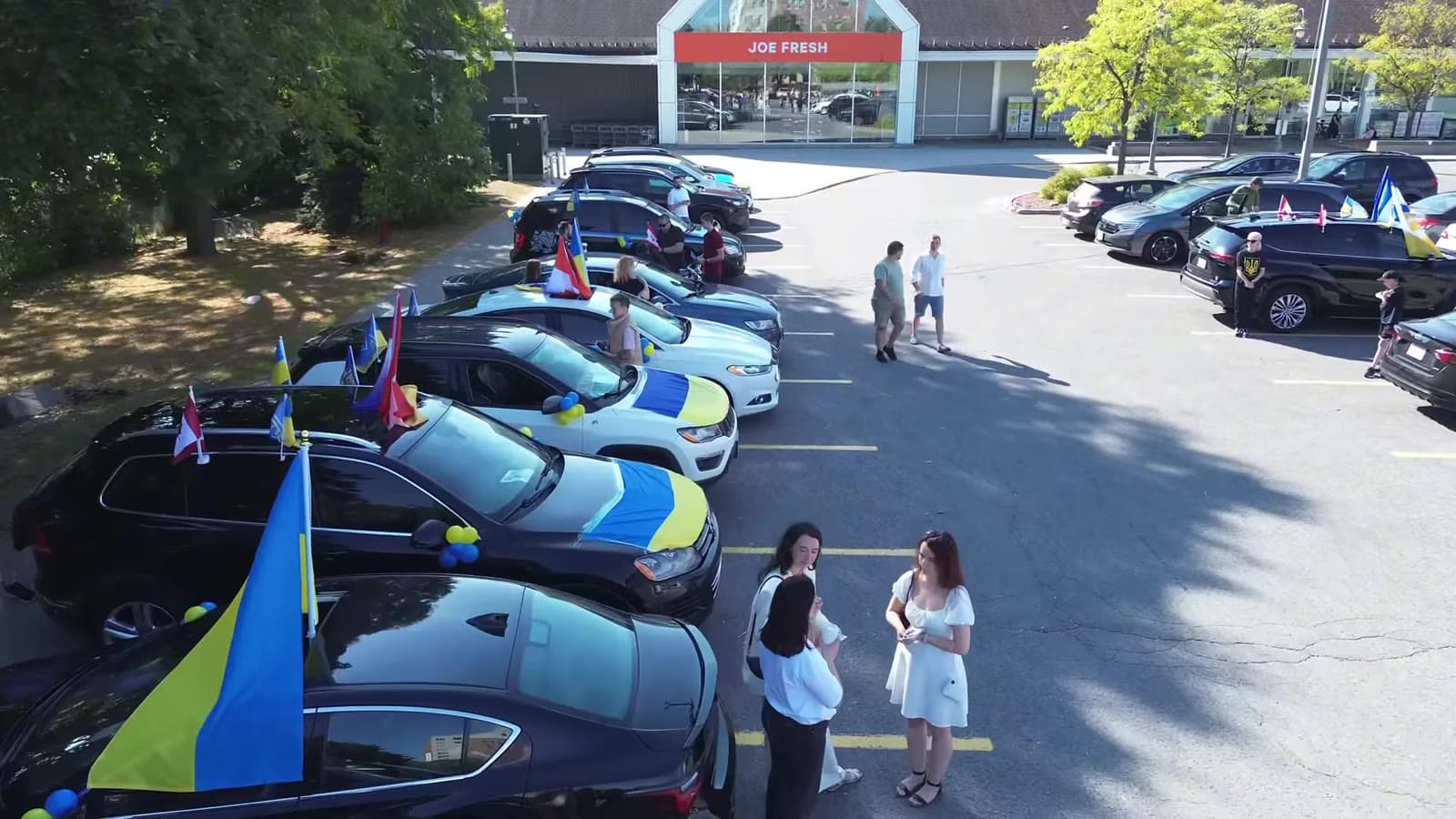 Flag-decorated cars assembling for the 2024 UAFest convoy