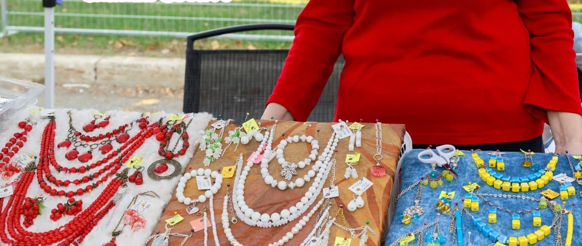A jewelry vendor's table set up with handmade necklaces, bracelets and earrings on display at UAFest