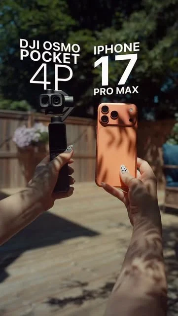 Two hands holding a DJI Osmo Pocket 4P and an orange iPhone 17 Pro Max side by side on a deck, labelled with both camera names