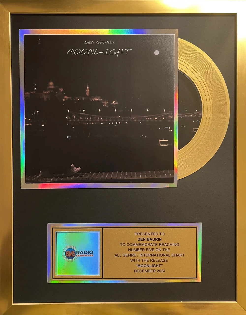 Framed gold-record award he published, from BMS Radio Network: presented to DEN BAURIN to commemorate reaching number five on the all genre / international chart with the release "MOONLIGHT", December 2024
