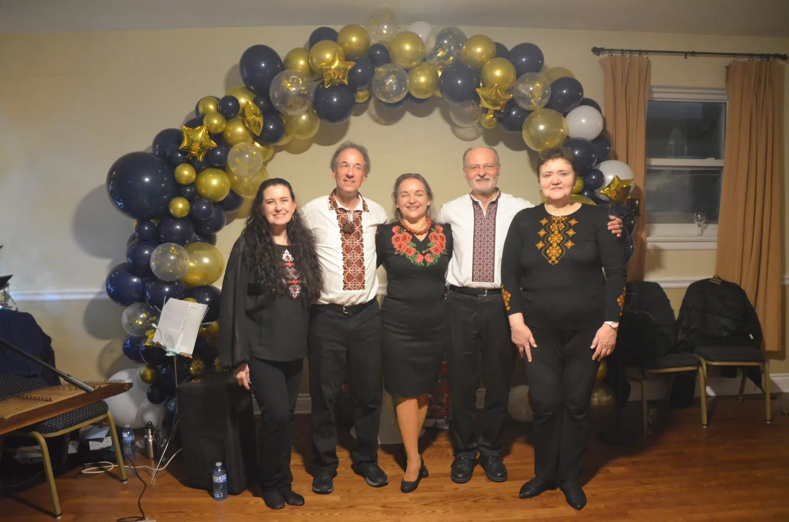 The band under a balloon arch in navy and gold