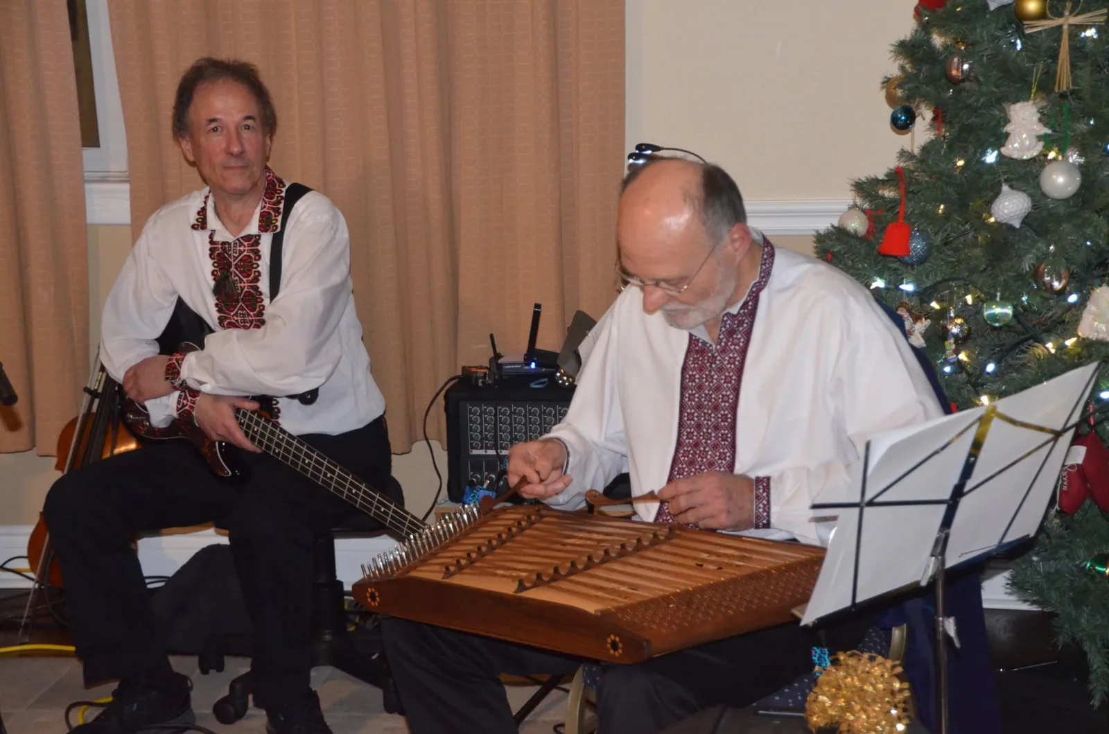 Roman playing the tsymbaly, with Mykola on bass guitar beside him