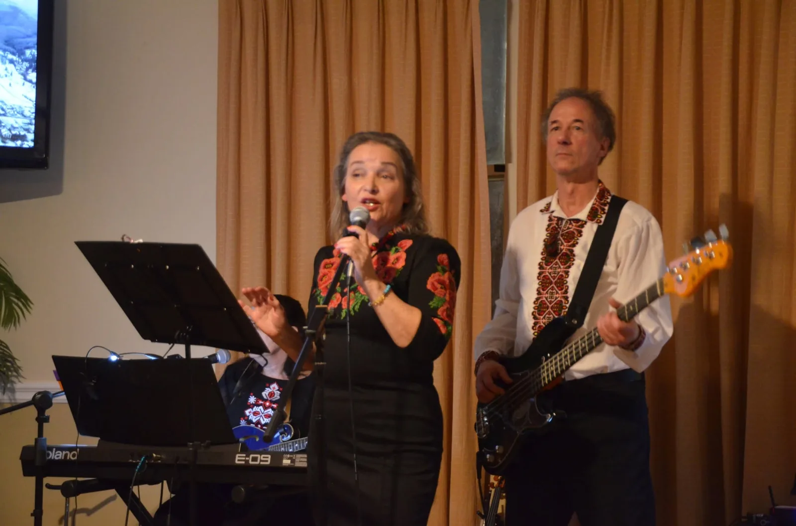 Olya singing lead with Mykola on bass guitar