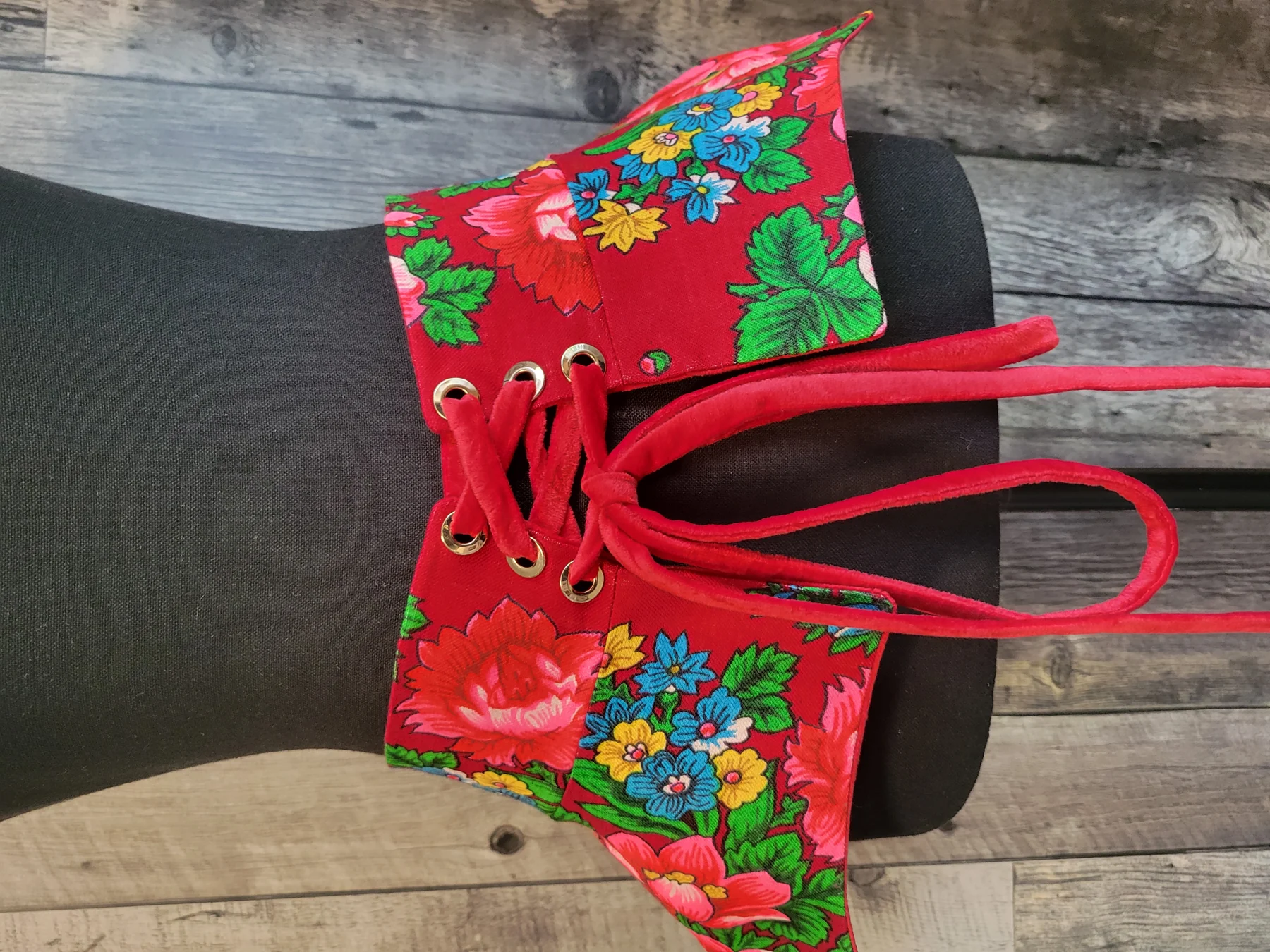 Baska "Любава" — a red laced waist piece sewn from an authentic Ukrainian floral headscarf, on a dress form
