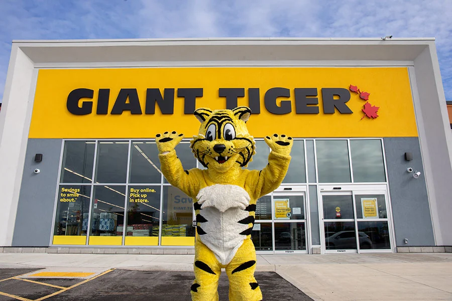 Friendly, the Giant Tiger — the company mascot — posing in front of a Giant Tiger store