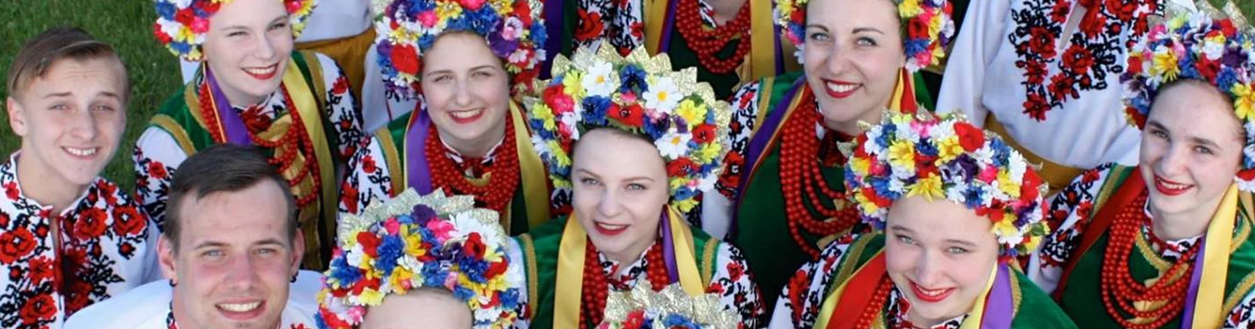 Dancers of the Troyanda Ukrainian Dance Ensemble in embroidered shirts, floral headdresses and coral beads, photographed from above