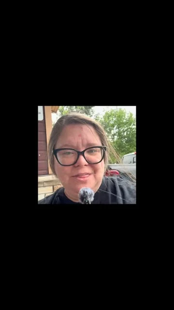 A woman in dark-framed glasses filming herself outdoors, from a reel on the That's Sew Cathy account