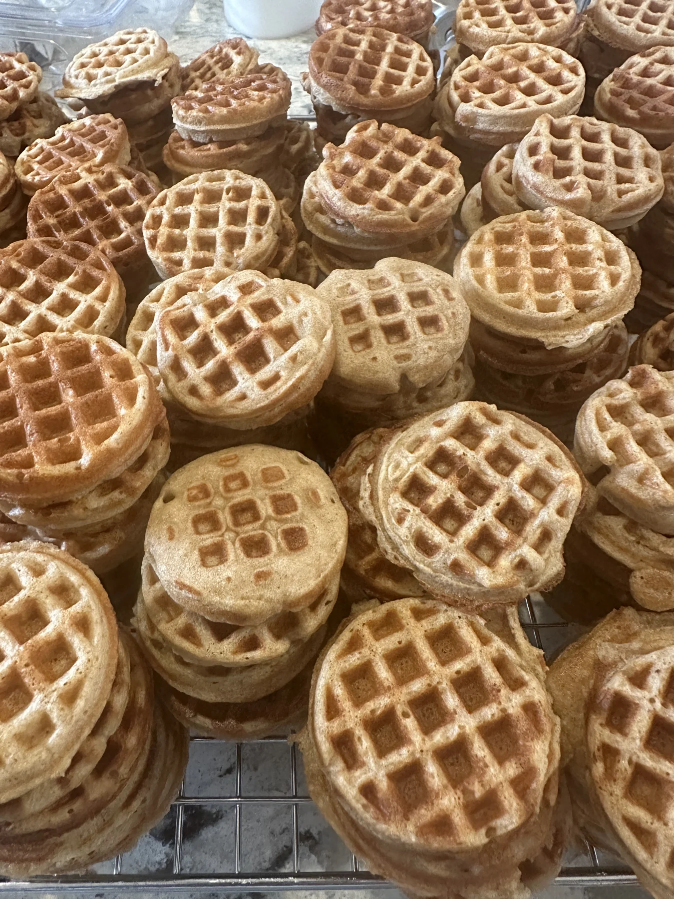 Stacks of waffle-shaped Banana Woofles, the product their shop calls "our #1 seller".
