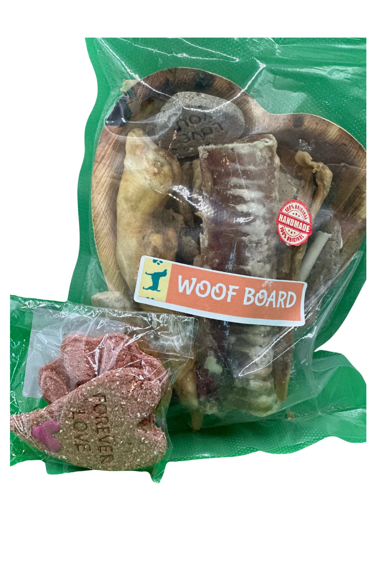 A vacuum-sealed Woof Board of mixed treats with a smaller pack of biscuits beside it.